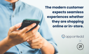 Person in a blue button-up shirt searching for a review on their phone. Text says: The modern customer expects seamless experiences whether shopping online or in-store