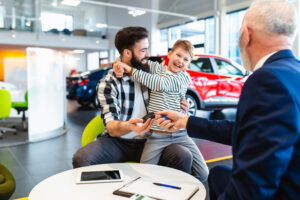 Loyalty in automotive - happy customers getting the keys to the car they purchased